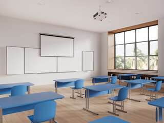 Cozy class room interior with table in row and blackboard with screen, window