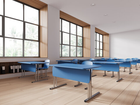 Cozy minimalist classroom interior with blue desk in row and panoramic window