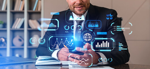 Businessman taking notes and using smartphone, digital dashboard and analytics