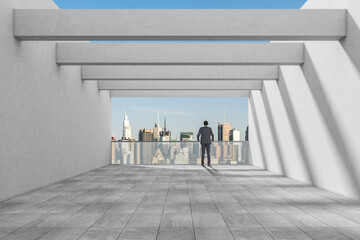 African businessman looking at city from office balcony