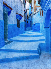 Bright blue street in Chefchaouen medina in Morocco.