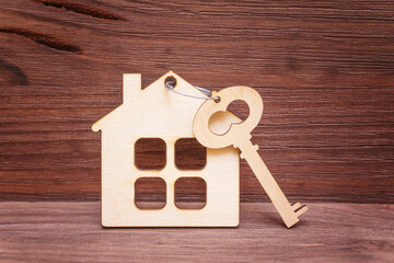 Flat House-Shaped Keychain and a Wooden Key