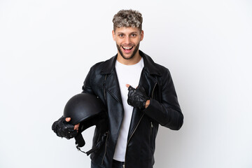 Young man with a motorcycle helmet isolated on white background with surprise facial expression
