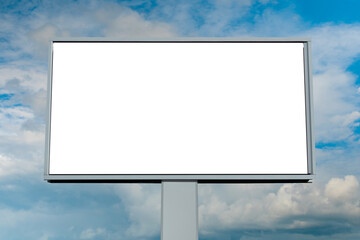 Mock up - blank white billboard or large advertising display against blue sky with white clouds. Consumerism, white screen, template, mock up and copy space concept