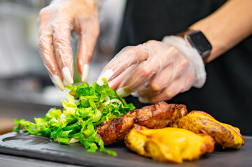 woman chef hand cooking grilled pork neck with baked potatoes and salad