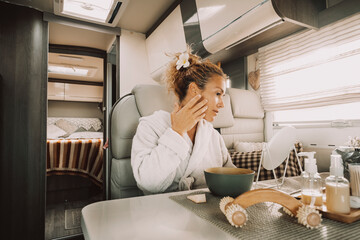 One woman having body skin care daily routine using products treatment on her face after a shower...