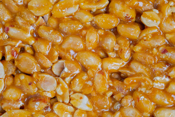 Caramelized nuts fried in honey - Gozinaki - orange granola peanut bar - close up, top view, macro....
