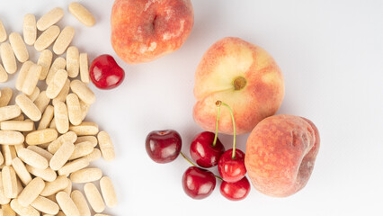 fruits and vitamin tablets. Comparison of natural products and artificial vitamins. Choice in healthy nutrition, balanced nutritional supplements