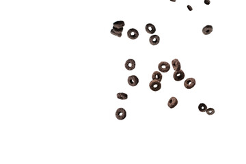 Chocolate rings cereal spill out into a bowl. Breakfast.