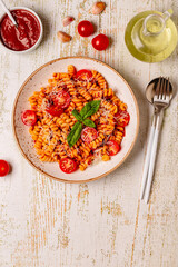 Homemade pasta with tomato sauce, top view.
