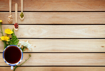 A cup of tea with flowers decorated with copy space wooden for Relax and calming down on top view....