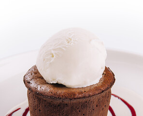 Chocolate fondant and a scoop of ice cream in a white plate