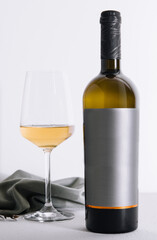 glass and bottle of wine on white