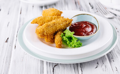 Fried chicken nuggets with ketchup on plate