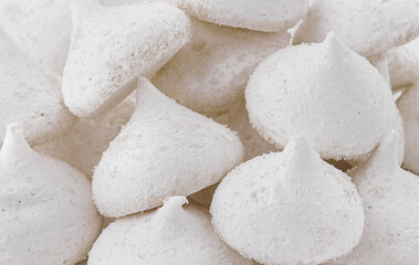 Bowl of meringue cookies close up background