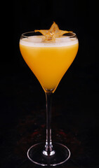 refreshing carambola martini cocktail with champagne