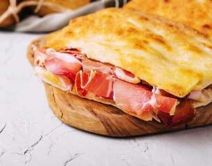 Tasty slices of focaccia bread with prosciutto crudo