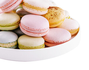 Multicolored macaroons on ceramic plate isolated on white
