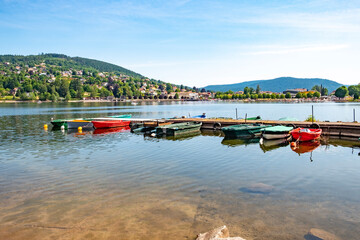 view to villge of Gerardmer with boats at the pier of lake Gerardmer in France