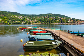 view to villge of Gerardmer with boats at the pier of lake Gerardmer in France