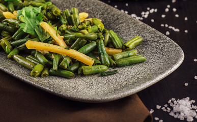 Fried wok green beans with onions and spices