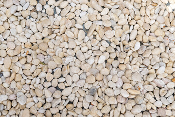 The floor is strewn with river pebbles.