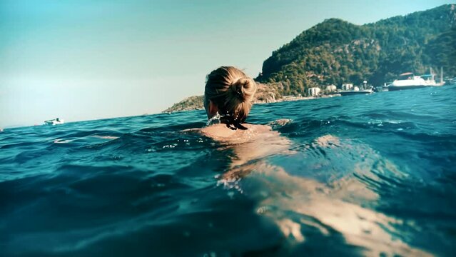 woman swimming underwater in sea in Kemer, Turkey