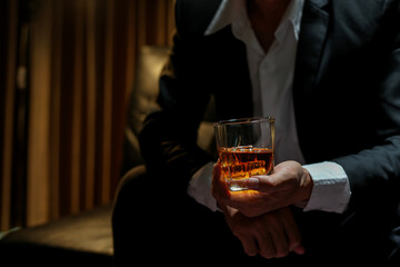 businessmen holding a glass of whiskey