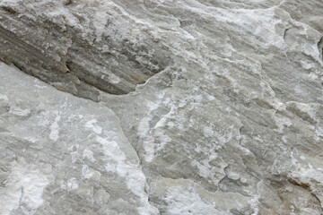 Background from the picture is made of limestone natural stone of pastel milky color with cracks