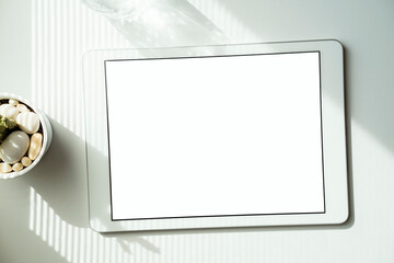 Fototapeta na wymiar Digital tablet mockup on white table. Sunlight and shadows on table