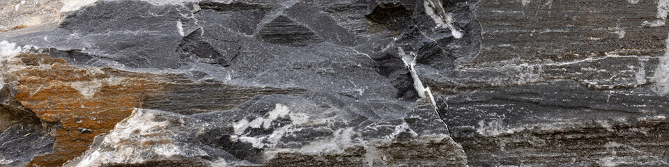 Fototapeta na wymiar Dark with gold and white inclusions natural stone in Alps 4x1 banner to social network, webdesign