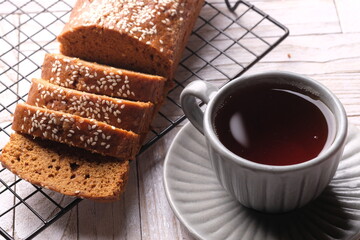 closeup of sesame-studded palm sugar bread slices on cooling rack. Indonesian traditional bread. Roti Ganjel Rel.