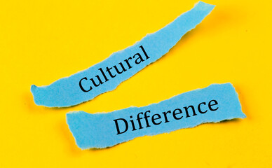 CULTURAL DIFFERENCE text on a blue pieces of paper on yellow background, business concept