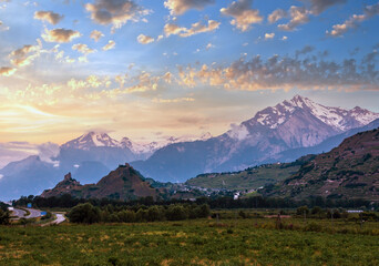 Alps mountain summer morning view with Castles Tourbillon and Montorge and snow covered rocky tops in far, Sion, Switzerland.