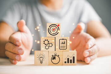 Obraz premium Hand arranging wood blocks in a step-by-step formation, symbolizing business strategy and Action plan. Copy space provided for professional presentations.