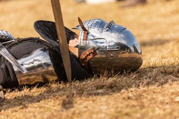 A defeated knight on the ground, at the feet of the victor