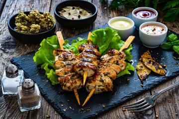 Souvlaki - grilled meat with vegetables on wooden background
