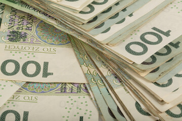 Background. Close up. A large stack of Polish 100 zloty banknotes.  Synonymous with wealth and...