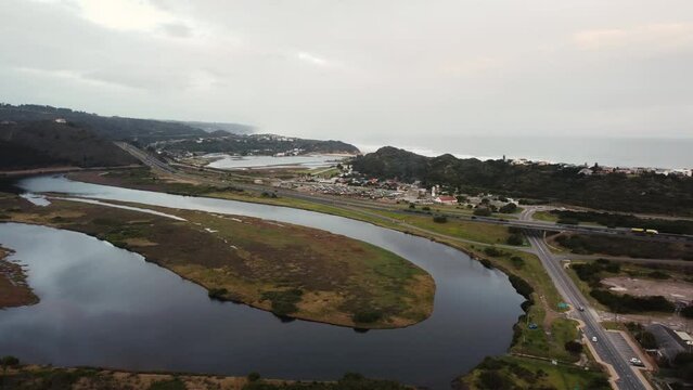 Aerial view of winding river near N2 high-way road in Groot Brakrivier, Western Cape, South Africa - 4K Resolution