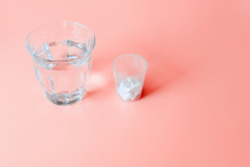 Medicine and health. A glass of water and a drink-a-pill glass.