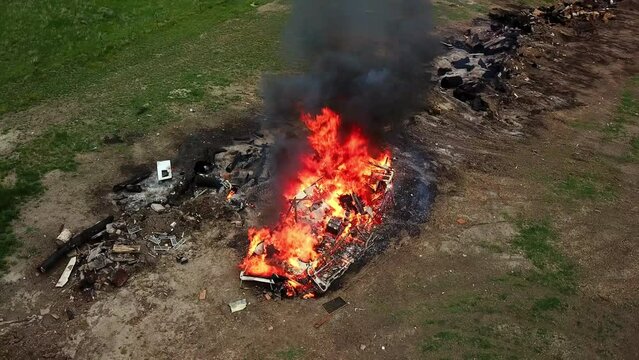 Aerial Panning Shot Of Burning Caravan Emitting Smoke Near People, Drone Flying Over Motor Home In Flames - Billings, Montana