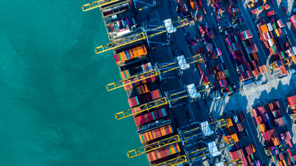 Aerial view over containers ship loading and unloading in sea port.Cargo ship import and export...