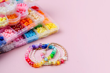 Kids handmade beaded jewelry and different multi-colored beads for children's needlework and crafts...