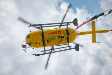 Flying helicopter of Emergency Medical Service against sky. Themes rescue, help and hope..
