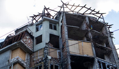Residential high-rise building after a strong fire. Apartments and balconies were destroyed by fire after being hit by a rocket. Facade of an abandoned high-rise building after a fire.