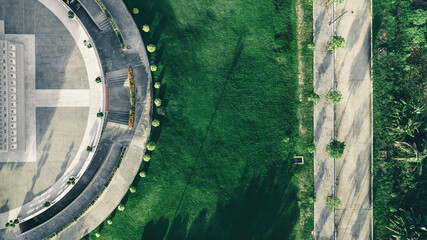 Top view aerial photo from a flying drone of a city park buddha park with a walking path and green zone trees