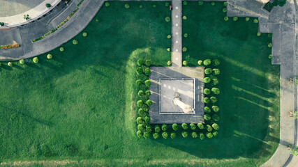 Top view aerial photo from a flying drone of a city park buddha park with a walking path and green...