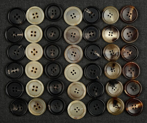 Stack Of Horn Buttons With Different Shades.. Set of buttons.