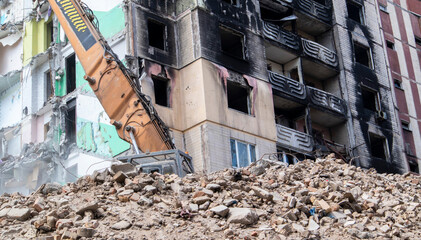 The process of demolition of the old dismantling of the building. The excavator breaks the house....