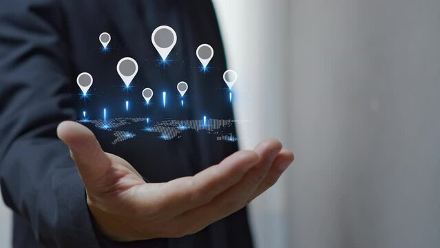 Professional businessman or investor shows world map and pin point location marker symbo on virtual screenl. GPS and navigation, investment in residential property and real estate business concept.